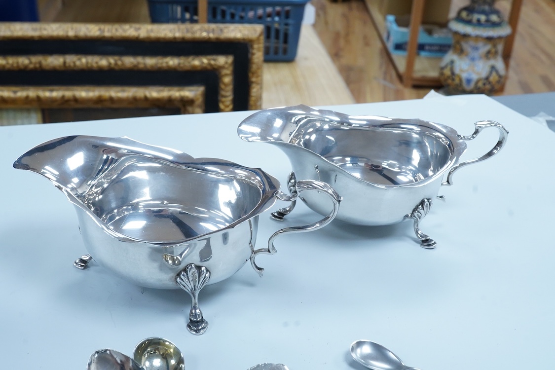 A pair of George VI silver sauceboats, with scroll handles, Stokes & Ireland, 1936, 16.2cm, together with four silver tennis related teaspoons (1 a.f.) and two small silver condiment spoons.